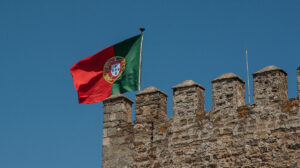 foto mostra bandeira de portugal do alto de uma construção